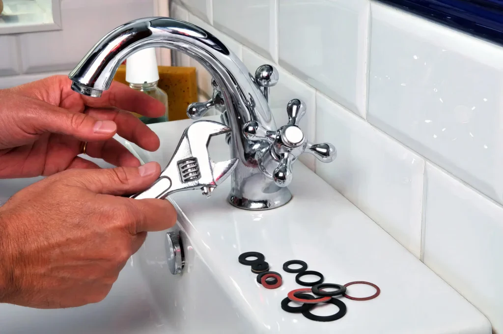 Plumber performing maintenance on a bathroom faucet in Bethel Park