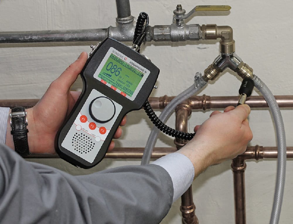 Plumber testing pipes with electronic leak detection equipment in Bethel Park