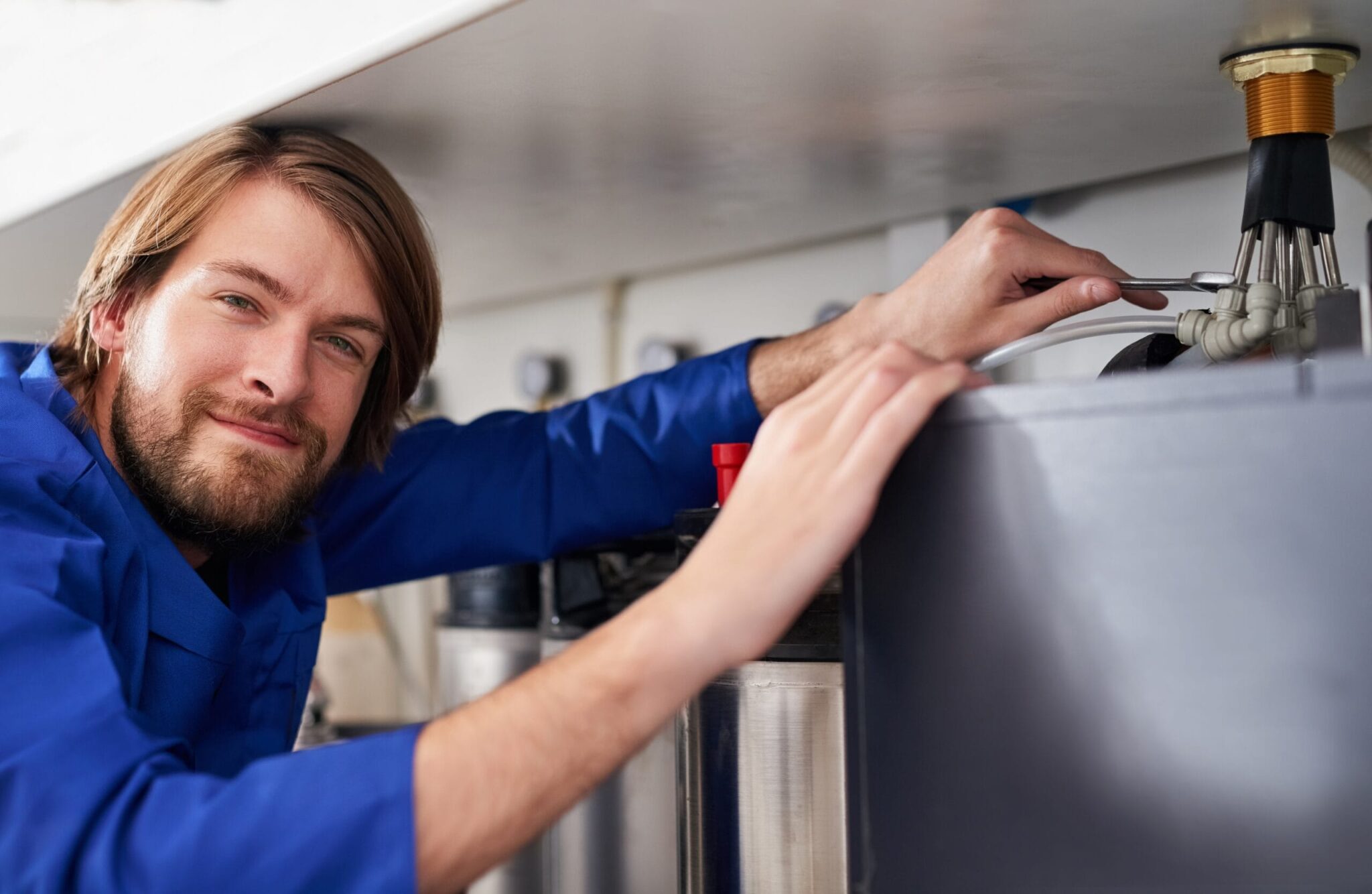 Technician servicing a residential water heater tank in Bethel Park